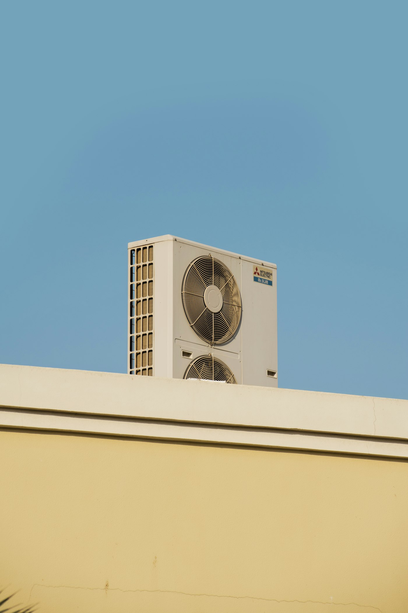 Air conditioning unit against a blue sky